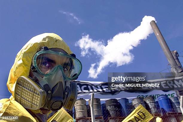 Member of the ecological group Greenpeace watches placards placed in the incinerator industrial sweepings company TriEco SA, located in Dock Sud, a...