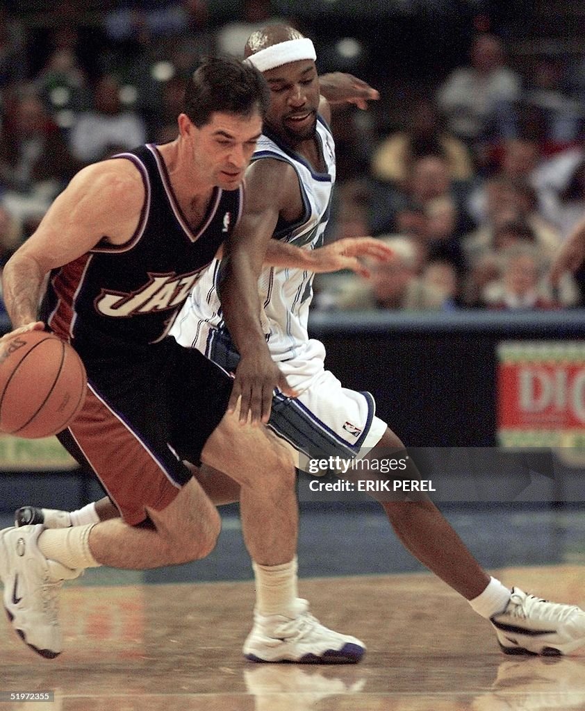 Utah Jazz's John Stockton (L) steals the ball from