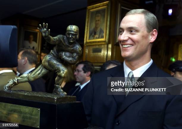 Heisman Trophy winner quarterback Chris Weinke of Florida State smiles while posing with his trophy 09 December 2000 at New York's Downtown Athletic...