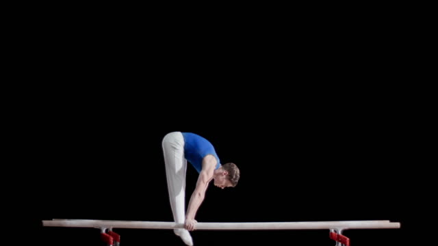 Female Gymnast Doing L-Sits on Parallel , Stock Video