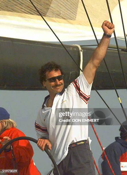 Winning helmsman Paul Cayard raises his arm in victory 26 April after Stars and Stripes crossed the finish line ahead of Mighty Mary in San Diego....