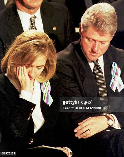 First Lady Hillary Clinton and US President Bill Clinton listen to a speech during a prayer service for the families of victims of the 19 April bomb...
