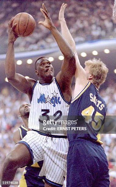 Orlando Magic's center Shaquille O'Neal is guarded by Indiana Pacers Rik Smits during first quarter action 23 May during game one of the Eastern...