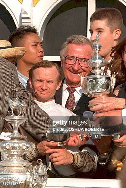 Timber Country co-owner Robert Lewis poses with the Woodlawn Vase with jockey Pat Day after his horse won the 120th running of the Preakness Stakes...