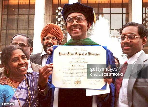 Balamurali Ambati of the US, holds up his diploma after receiving his MD from the Mt. Sinai School of Medicine 19 May in New York. Ambati, believed...