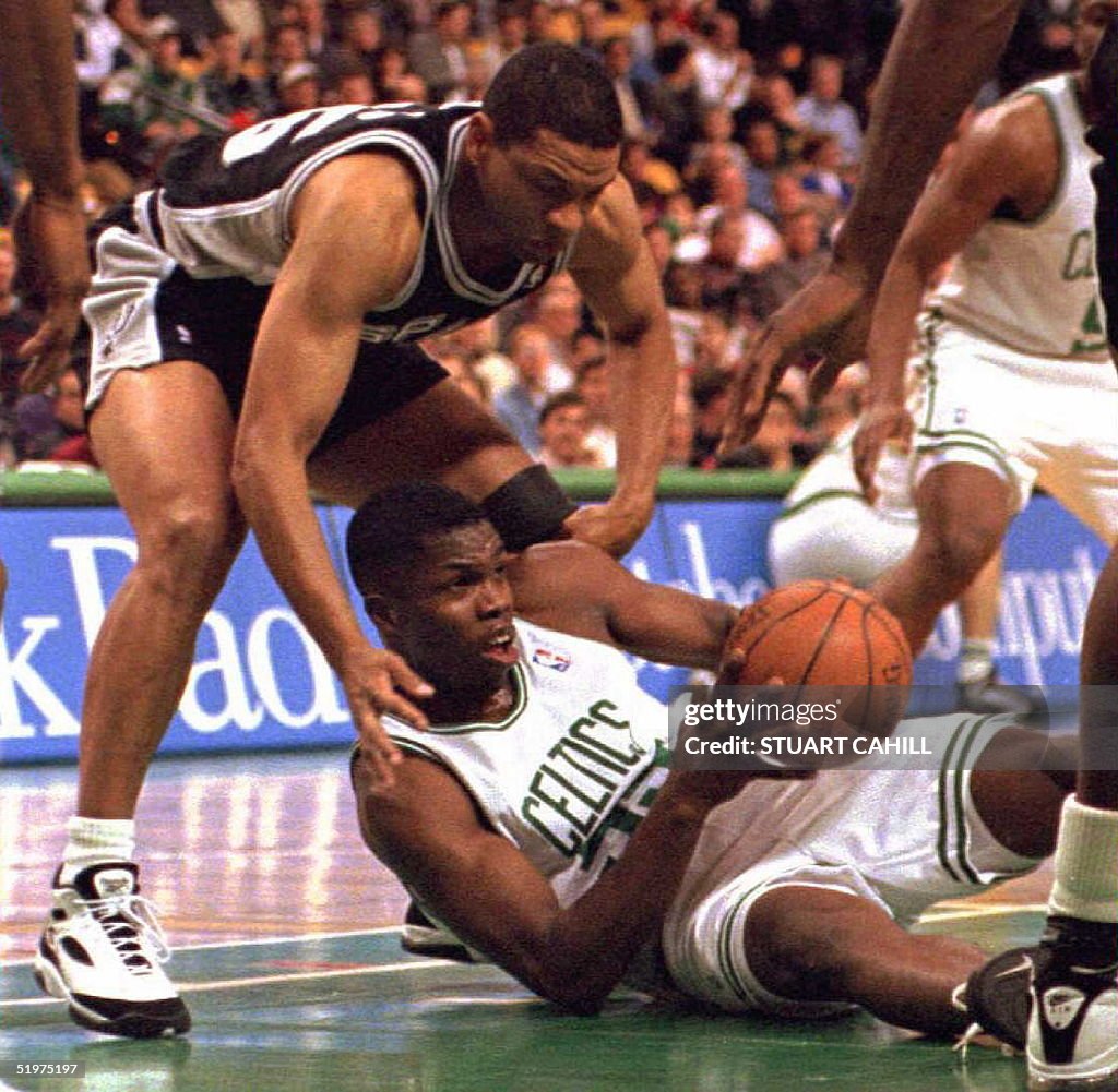 Boston Celtics' Eric Williams (below) battles for