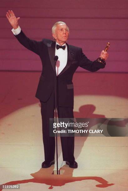 Actor Kirk Douglas salutes the crowd at the 68th Annual Academy Awards after he received an Oscar for life time achievment 25 March in Los Angeles.