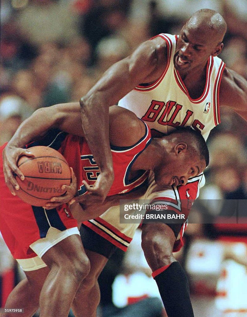 Chicago Bulls' guard Michael Jordan (top) puts pre