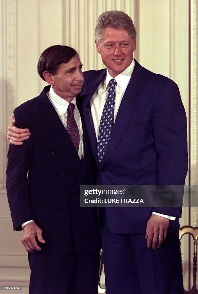 US President Bill Clinton (R) hugs US Trade Repres