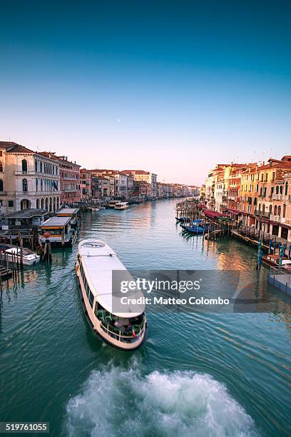 typical boat passing on grand canal, venice, italy - canale grande venedig stock-fotos und bilder