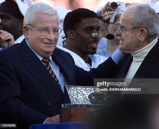 Baltimore Ravens owner Art Modell is given the Lamar Hunt Trophy from the San Diego Chargers' owner Alex Spanos after the AFC Champioship Playoff...