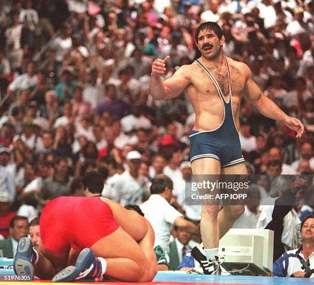 Iran's Abbas Jadidi reacts after being defeated by Kurt Angle of the US in the final bout of the men's Olympic freestyle 100kg wrestling 31 July at...