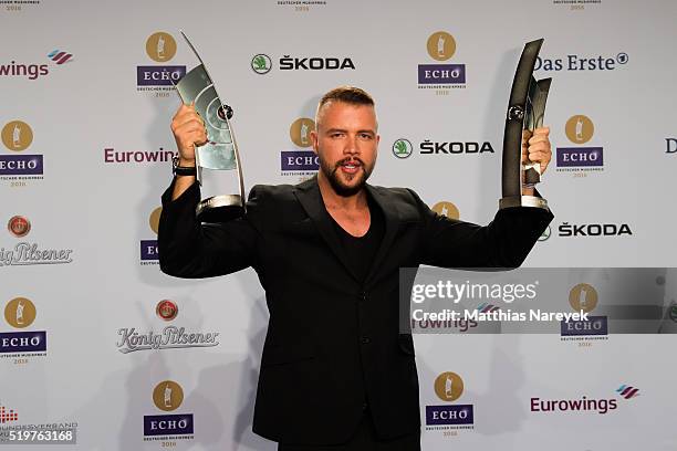 Kollegah poses with his awards at the winners board during the Echo Award 2016 on April 7, 2016 in Berlin, Germany.