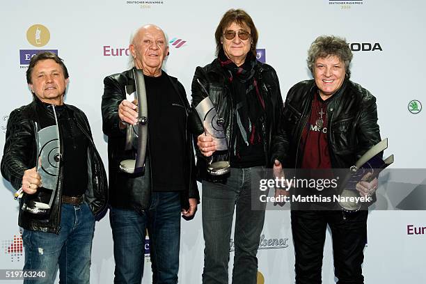 Klaus Scharfschwerdt, Peter Meyer, Dieter Birr and Dieter Hertrampf, musicians of the band Puhdys, pose with their awards at the winners board during...