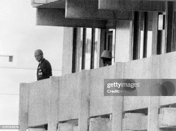 Palestinian militant appears on the balcony of the Israeli house watching an official on September 05, 1972 at the Munich Olympic village. A group of...