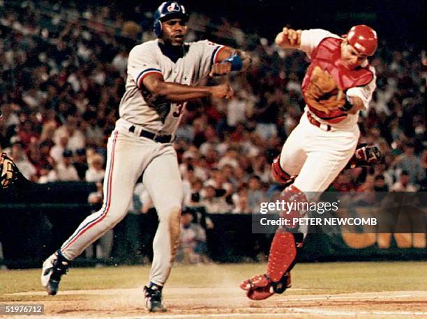 Montreal Expo Cliff Floyed sends St. Louis Cardinal catcher Tom Pagnozzi flying as he tries to score in the sixth inning. Pagnozzi held onto the ball...