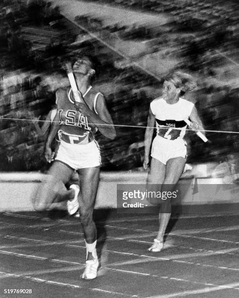 Nicknamed "the black gazelle", U.S champion Wilma Rudolph crosses victoriously the finish line of the Olympic 4 X100m event, in front of German Jutta...