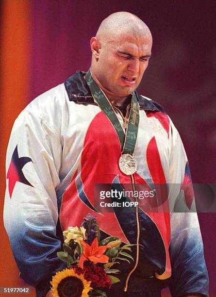Matt Ghaffari of the US sobs on the podium after losing to Russian Alexander Karelin in the Olympic super heavyweight Greco-Roman wrestling final 23...