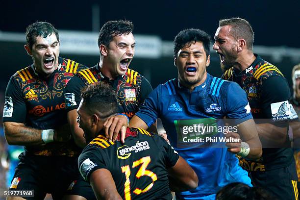 Stephen Donald,James Lowe and Aaron Cruden celebrate the try from Seta Tamanivalu during the round seven Super Rugby match between the Chiefs and the...