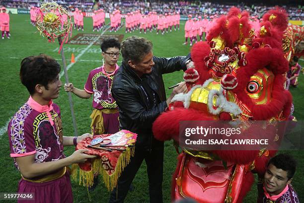 David Hasselhoff paints the head of a Chiense Dragon to bring good luck during the opening ceremony of the rugby sevens tournament in Hong Kong on...