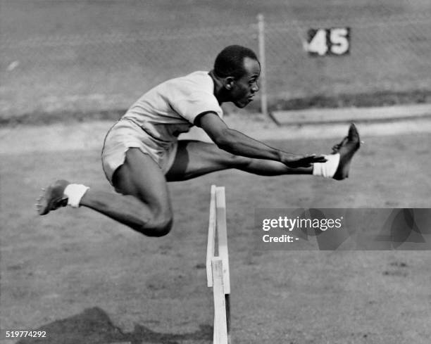 Harrison Dillard jumps a hurdle during his training at the athletics event of the London 1948 Olympic Games, in July 1948 in London. Dillard won gold...