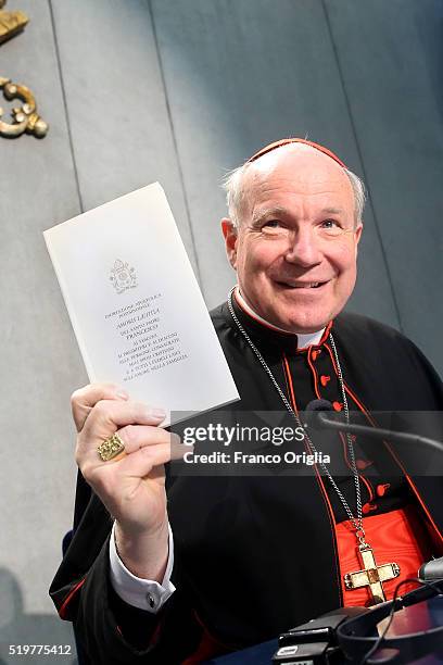 Cardinal Christoph Schonborn holds a copy of Pope Francis' post-synodal Apostolic Exhortation 'Amoris Laetitia' or 'The Joy of Love' at the Holy See...