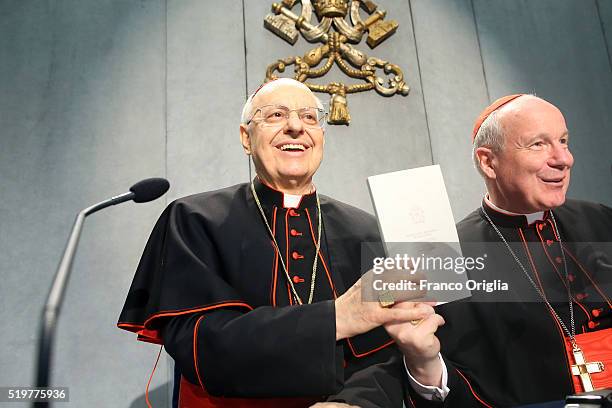 Cardinal Lorenzo Baldisseri and Cardinal Christoph Schonborn hold a copy of Pope Francis' post-synodal Apostolic Exhortation 'Amoris Laetitia' or...