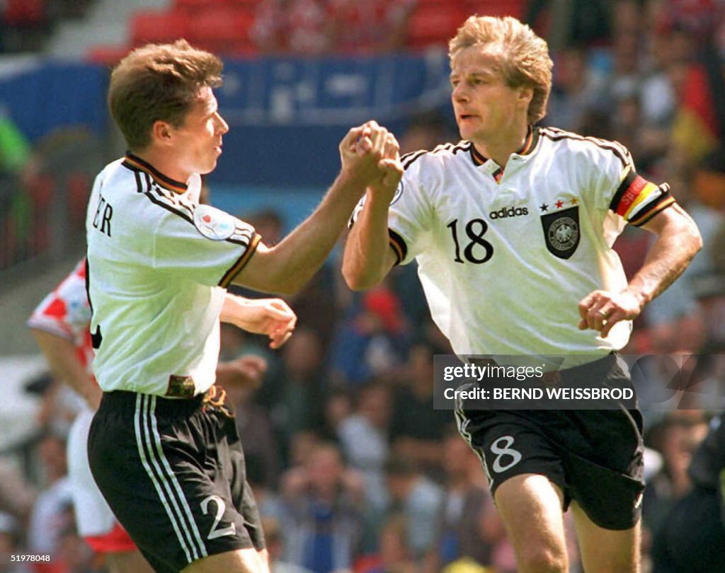 German player Stefan Reuter (L) congratulates capt