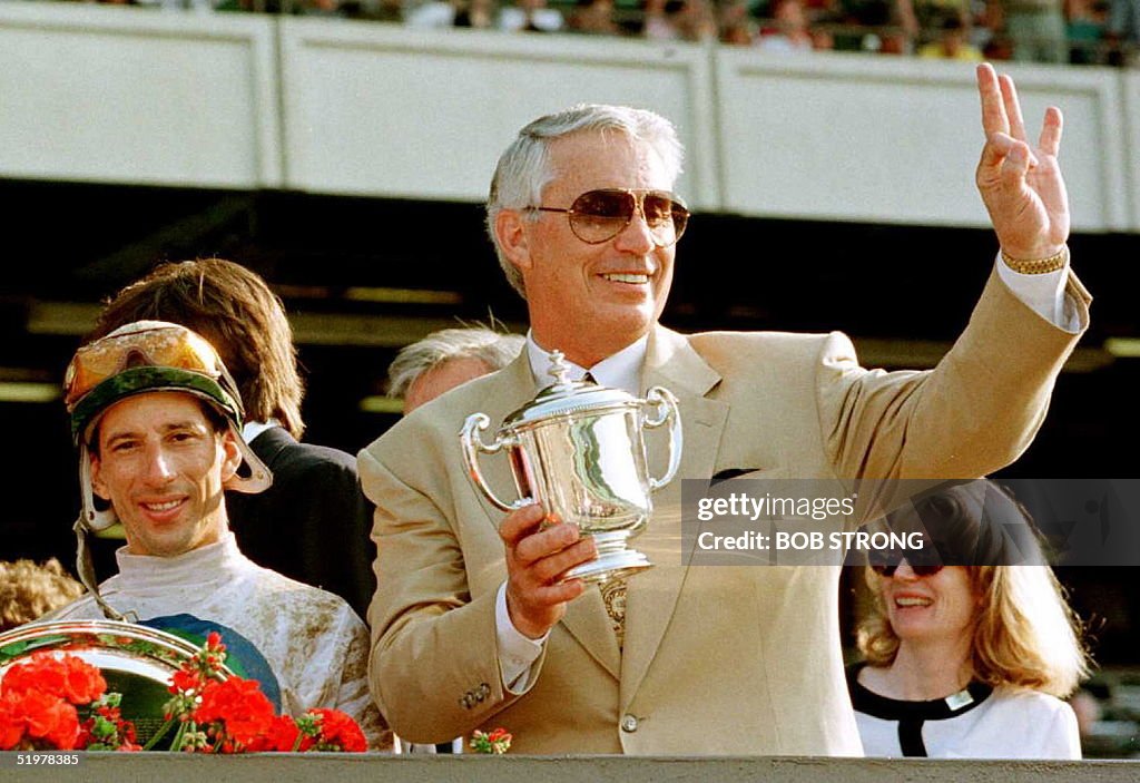 Trainer D. Wayne Lukas (R) gives the O.K. sign al