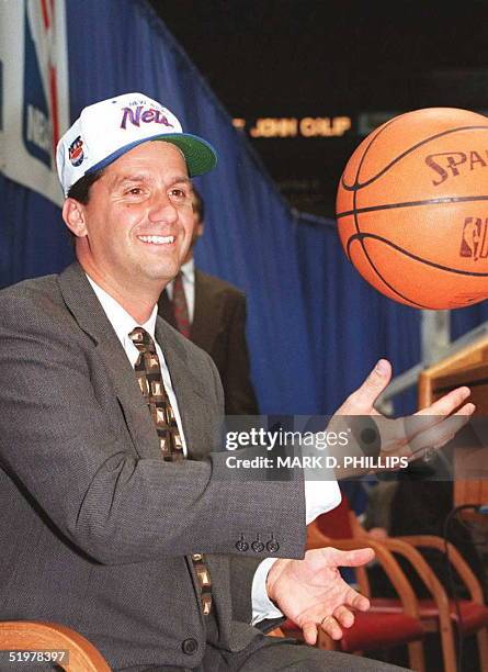 Former University of Massachusetts basketball coach John Calipari tosses a basketball as he meets the media at the Meadowlands Arena for a press...