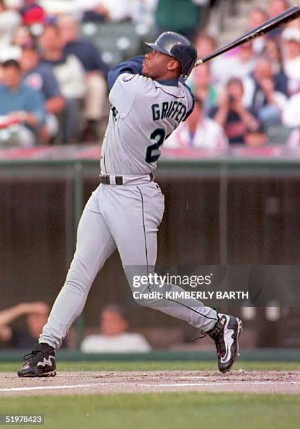Seattle Mariners Ken Griffey, Jr. Watches the ball go over the fence as he slams a three-run home run off of Cleveland Indians Brian Anderson during...