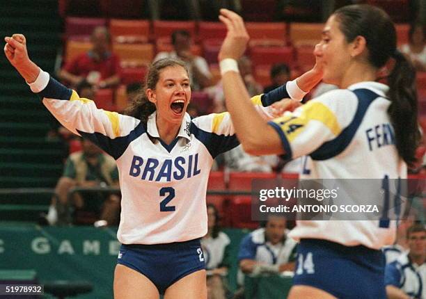 Brazilian players Ana Moser and Fernanda Venturini celebrate 28 July after their team defeated Germany in their Olympic volleyball preliminary Pool B...