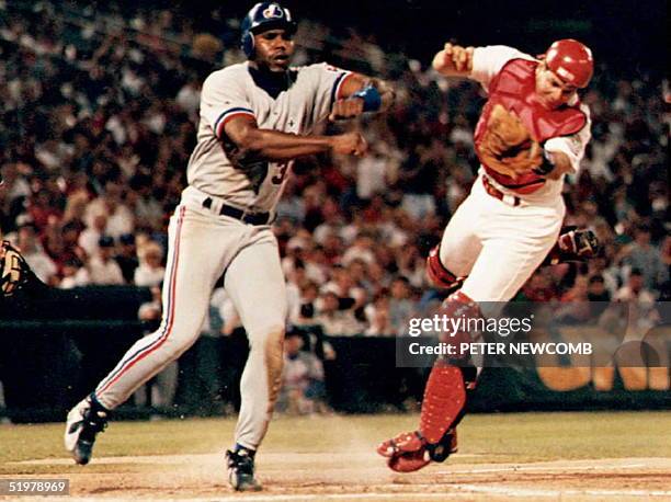 Montreal Expo Cliff Floyed sends St. Louis Cardinal catcher Tom Pagnozzi flying as he tries to score in the sixth inning. Pagnozzi held onto the ball...