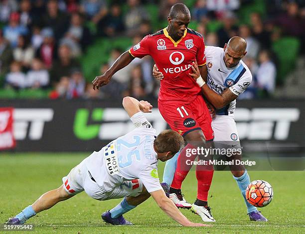 Marcelo Carrusca of United competes for the ball against Jacob Melling of Melbourne City and Patrick Kisnorbo during the round 27 A-League match...