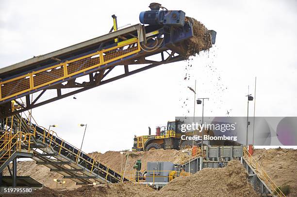 Front-loader truck and a mine feed conveyor operate at the MZI Resources Ltd. Keysbrook mineral sands mine in Keysbrook near Perth, Australia, on...
