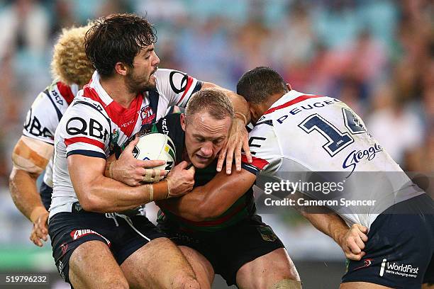 Jason Clark of the Rabbitohs is tackled during the round six NRL match between the South Sydney Rabbitohs and the Sydney Roosters at ANZ Stadium on...