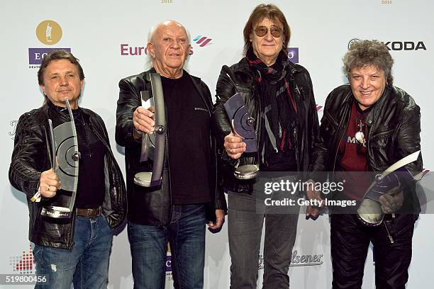 Klaus Scharfschwerdt, Peter Meyer, Dieter Birr and Dieter Hertrampf, musicians of the band Puhdys, pose with their awards at the winners board during...