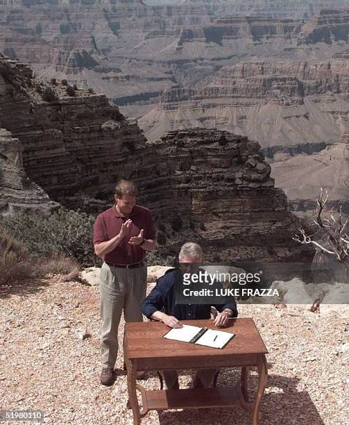 President Bill Clinton signs an order in Grand Canyon National Park in Arizona to designate a vast canyonland in Utah, including Grand Escalante...