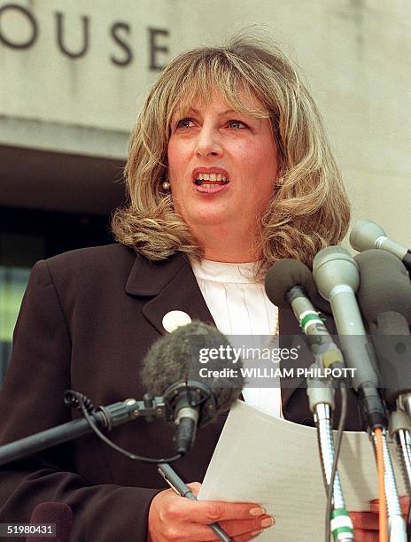 In this 29 July 1998 file photo, Linda Tripp talks to reporters outside of the Federal Courthouse 29 July 1998 in Washington, DC, following her...