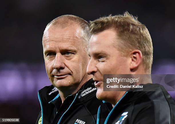 Ken Hinkley the coach of the Power and Michael Voss assistant coach of the Power walk onto the field during the round three AFL match between the...