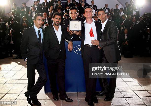 French actors Sami Bouajila, Bernard Blancan, Roschdy Zem, Jamel Debbouze pose with director Rachid Bouchareb during a photocall after winning the...