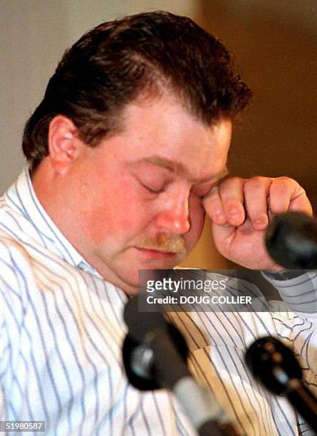 Richard Jewell wipes a tear from his eye during a press conference 28 October in Atlanta, Ga. Jewell was cleared as a suspect in the July 27 bombing...