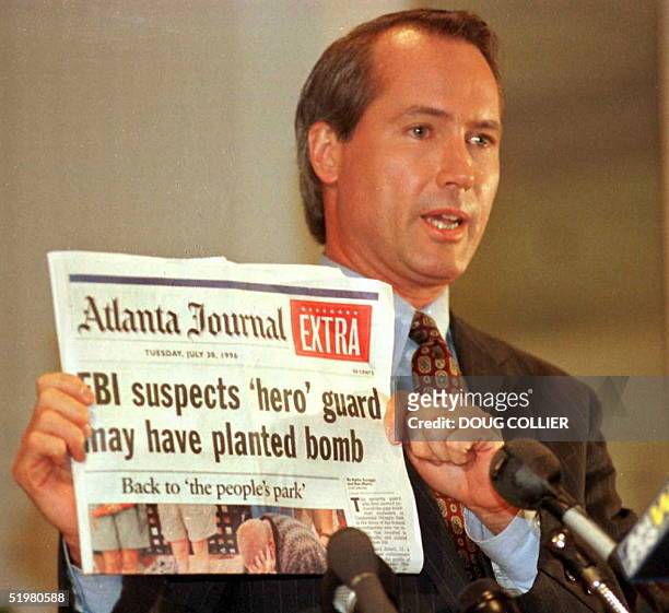 Richard Jewell Attorney Lin Wood holds a copy of the Atlanta Journal during a press conference 28 October in Atlanta, Ga. Wood said Jewell plans to...