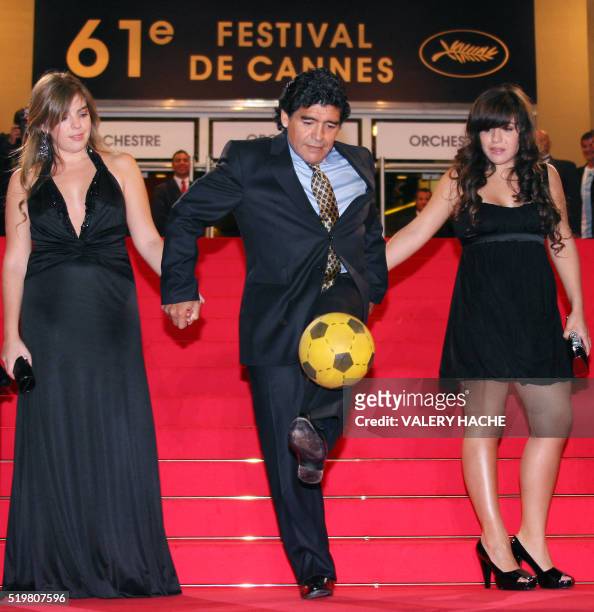 Former Argentinian football player Diego Maradona dribbles with a ball as he arrives with his daughters Dalma and Giannina to attend the screening of...