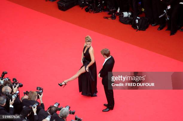 French actress Vahina Giocante performs to her partner, French designer Ora Ito, as they arrive to attend the opening ceremony and the screening of...