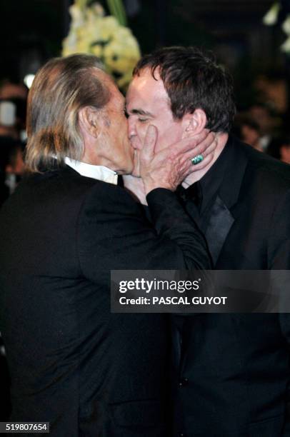 Actor David Carradine kisses US director Quentin Tarantino as they arrive for the official projection of the film "Kill Bill 2", 16 May 2004 during...