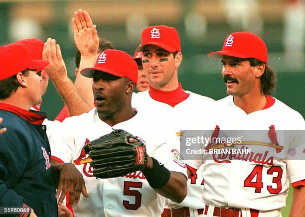 St. Louis Cardinals Ron Gant , John Mabry and Dennis Eckersley celebrate their 3-2 victory over the Atlanta Braves 12 October in game three of the...