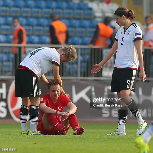 Melike Pekel of Turkey cries as Leonie Maier and Annike Krahn of Germany console her after the UEFA Women's Euro 2017 Qualifier match between Turkey...