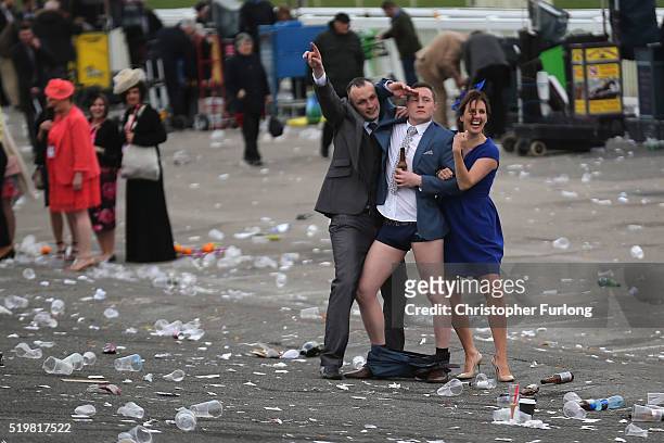 Man plays to the cameras as racegoers make their way home at the end of Ladies Day the second day of the Aintree Grand National Festival meeting on...