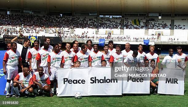 Children form the word Peace in various languages in front of F1 racing pilot Michael Schumacher of Germany , Jarno Trulli and Giancarlo Fisichella,...